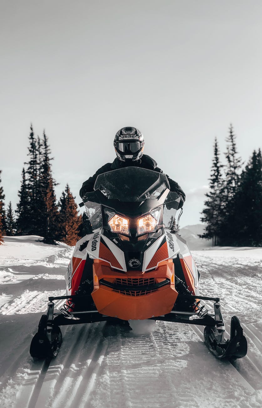 photo of person riding snowmobile