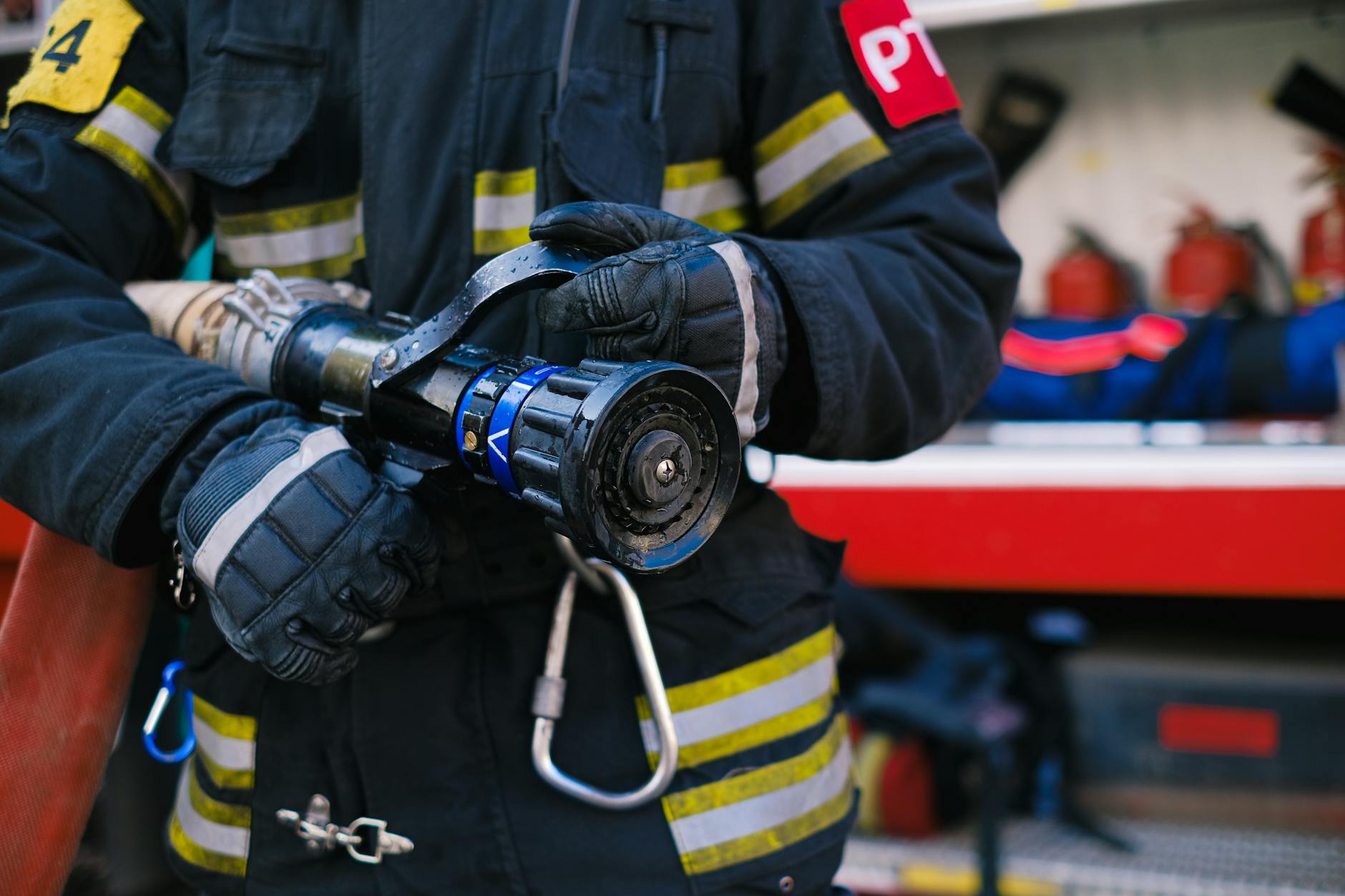 close up of a firefighter holding a firehose