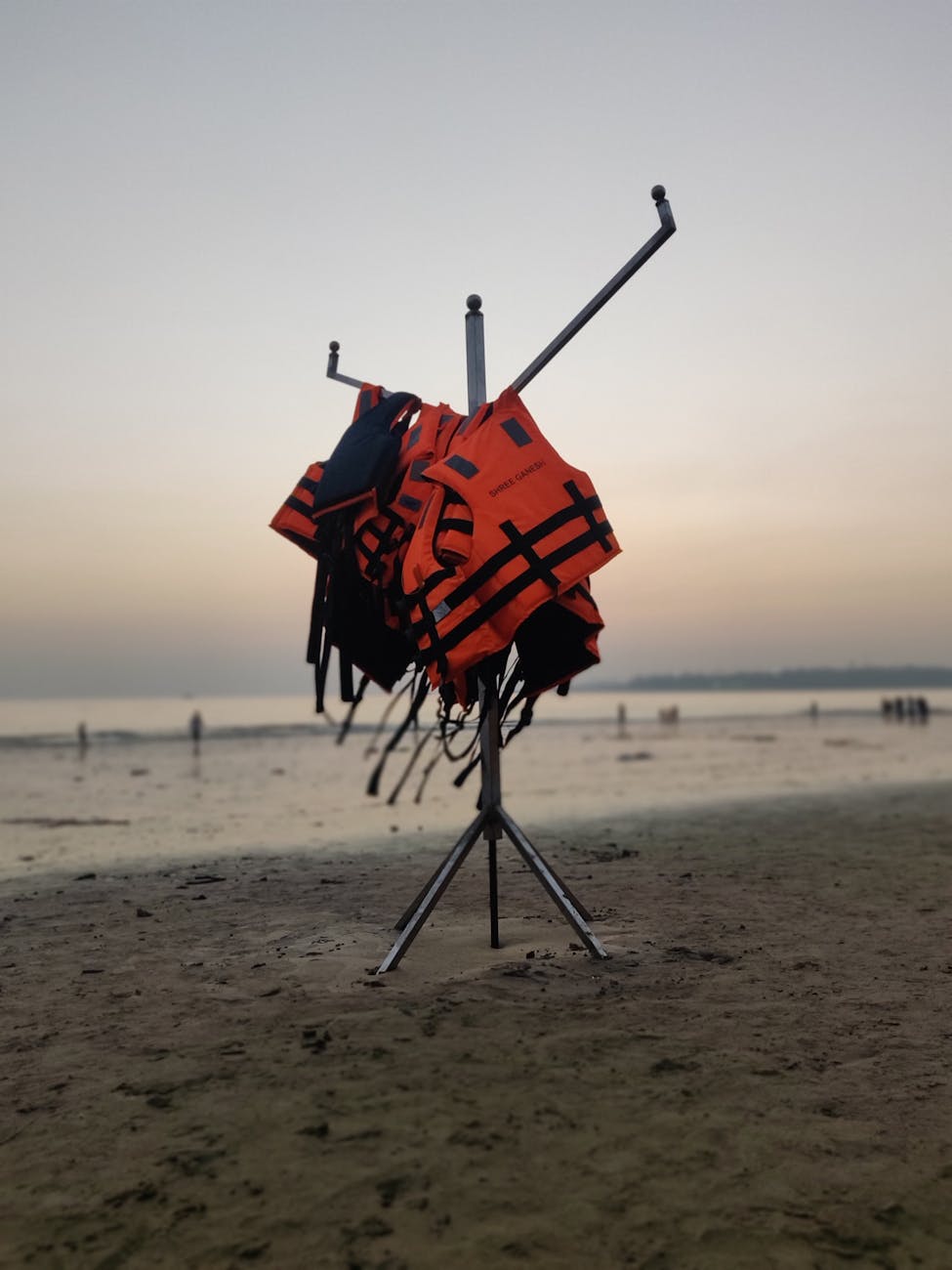photograph of orange life vests at the beach