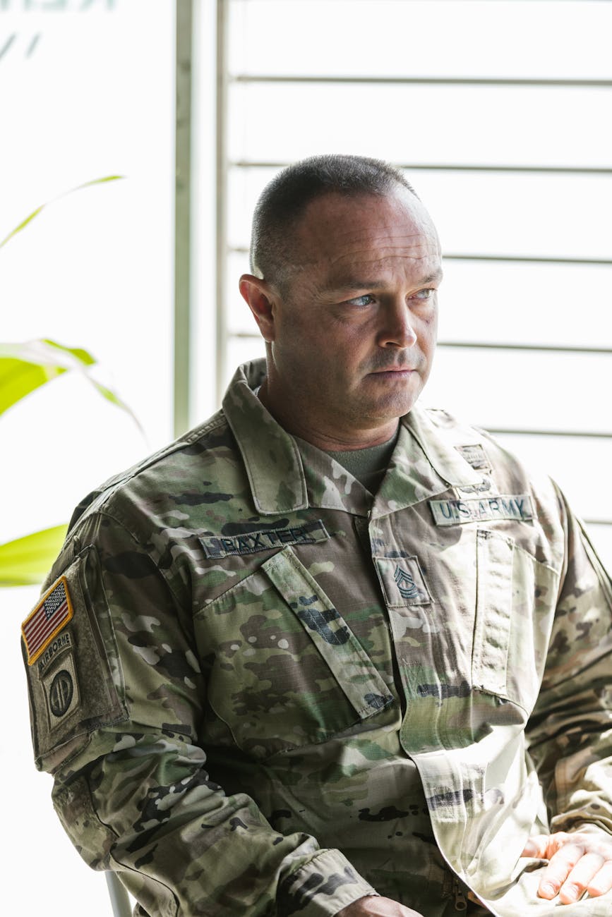 photo of man in gray and black camouflage uniform
