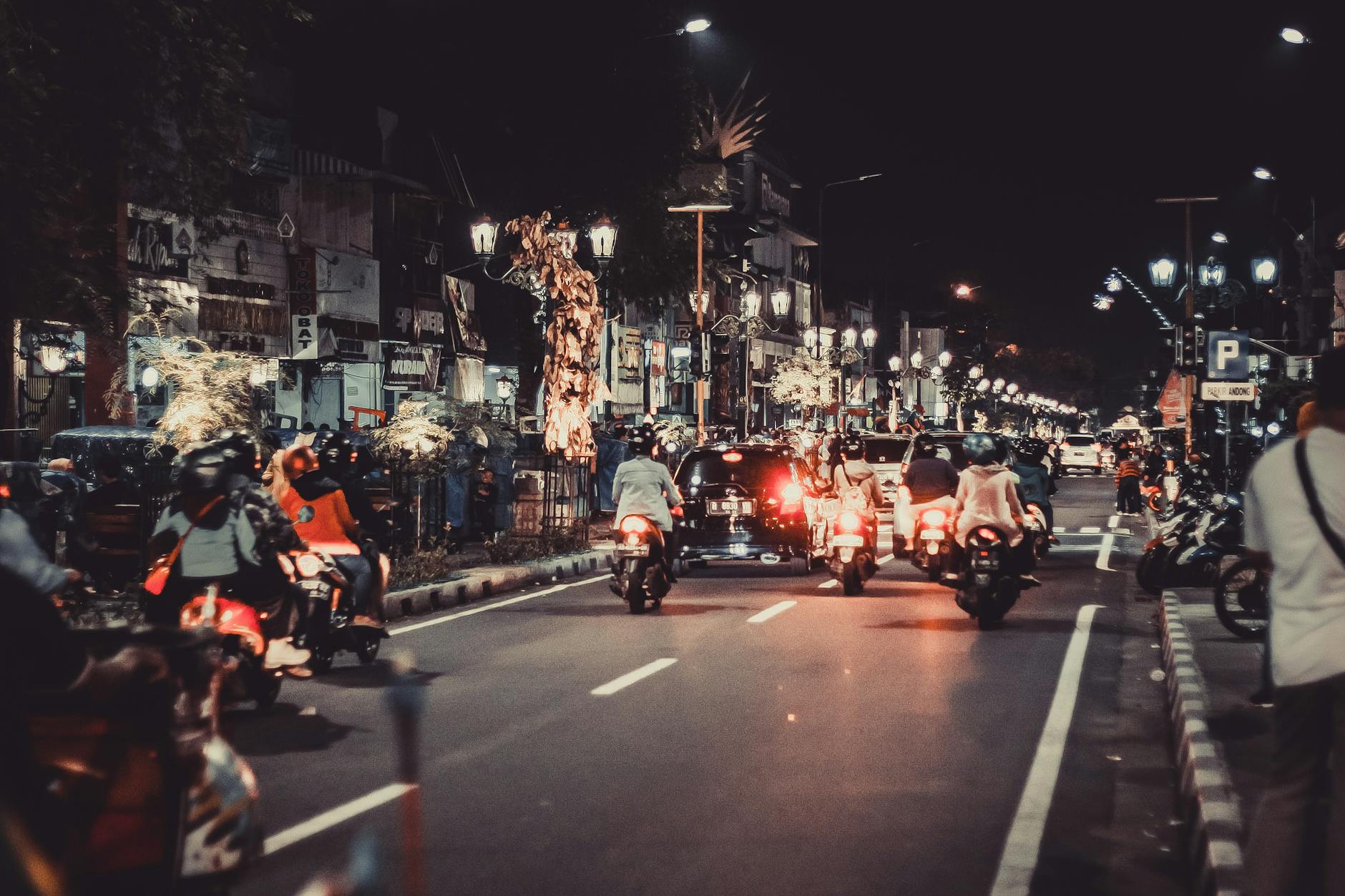 people riding motorcycles on road during night time